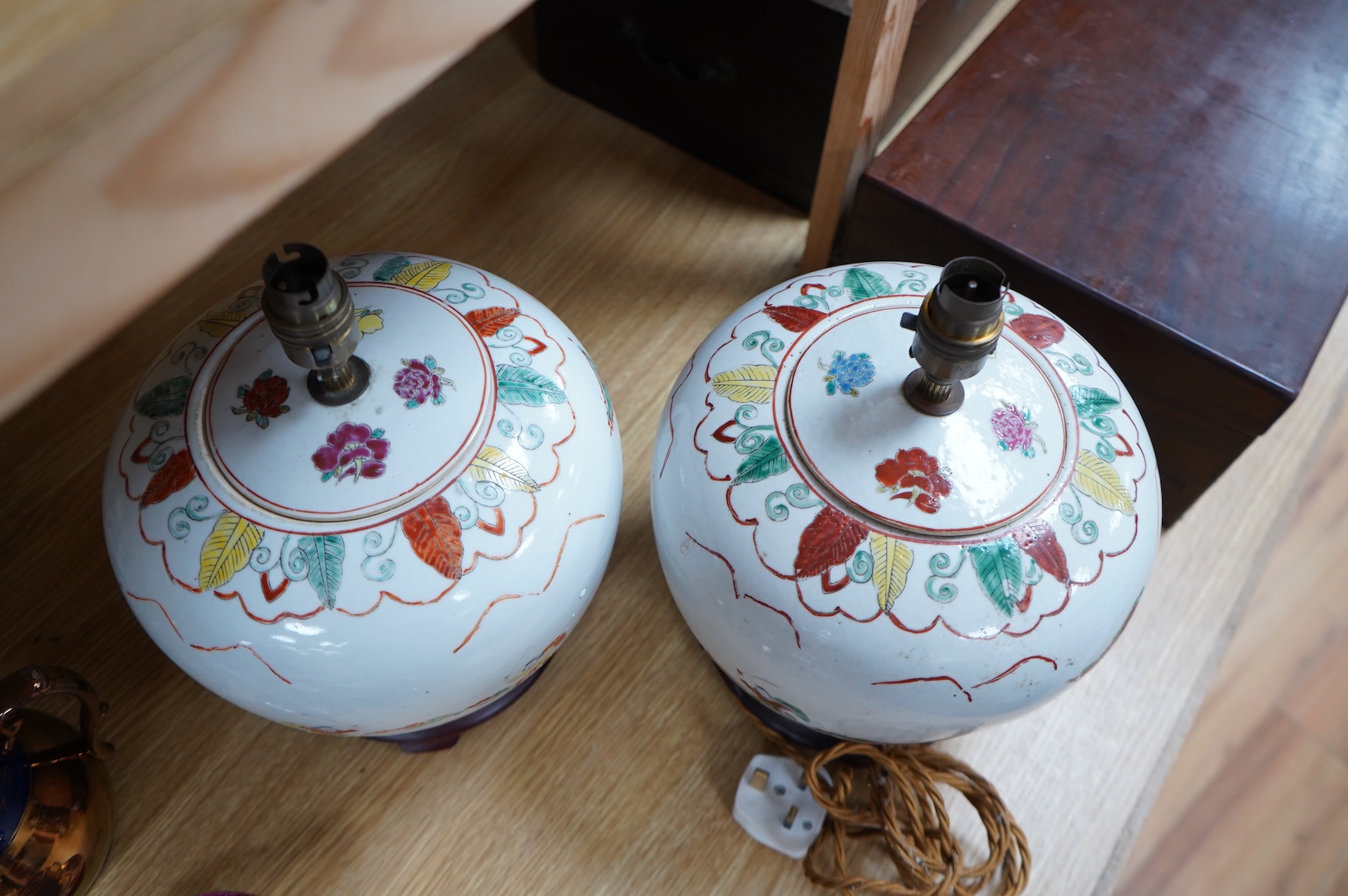 A pair of Chinese jar and covers on stands, converted later to lamps, 34cm including fittings.